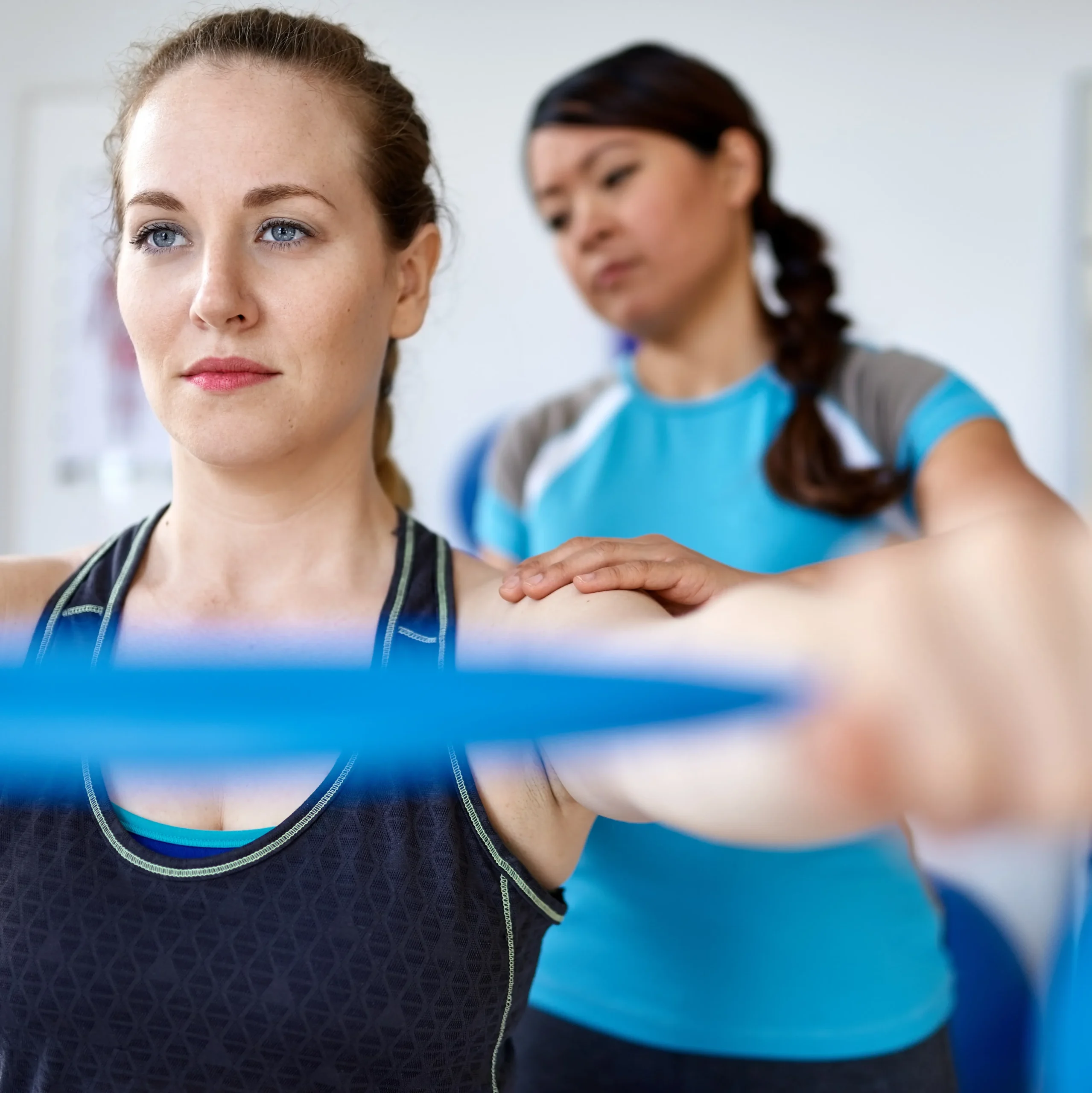 Physical Therapist giving patient care with resistance band.